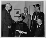 E. W. Bertner in Academic Regalia Shaking hands with Jesse Jones, Accompanied by P. P. Butler, Dr. W. H. Moursund, and Dr. W. R. White by Arrow Arts Studios
