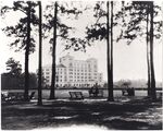 Hermann Hospital with People on Benches at Hermann Park by Hermann Hospital (Houston, Tex.)