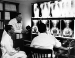 Examining X-ray photographs at Hermann Hospital