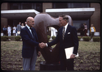 Denton Cooley and an unidentified man in front of A Symbol of Excellence by John P. McGovern Historical Collections & Research Center