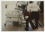 Paramedics Load Infant Incubator into Ambulance at Jefferson Davis Hospital by Jim DeLeon