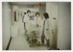 Doctors Rroll Infant Iincubator Down the Hallway by Jim DeLeon