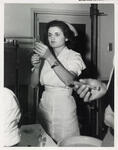 Louise Cavagnaro Examining a Syringe by Atomic Bomb Casualty Commission