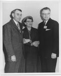 Emmeline Renis Standing with two Men