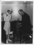 May Poloc and W.F. Norman threading a movie projector by San Jacinto Lung Association